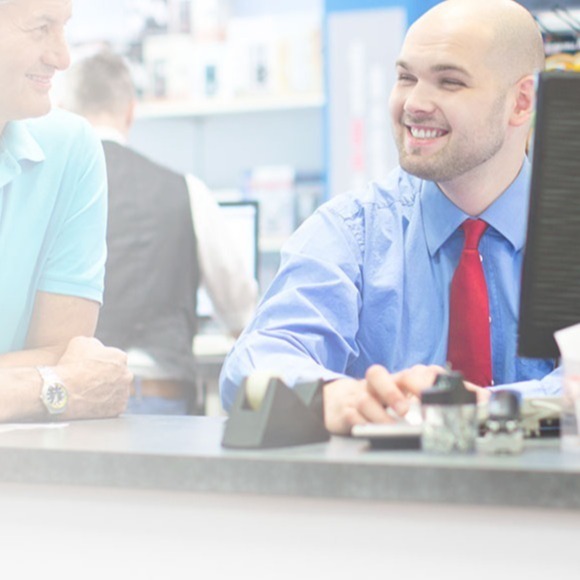 Customers-at-the-counter-with-sales-man