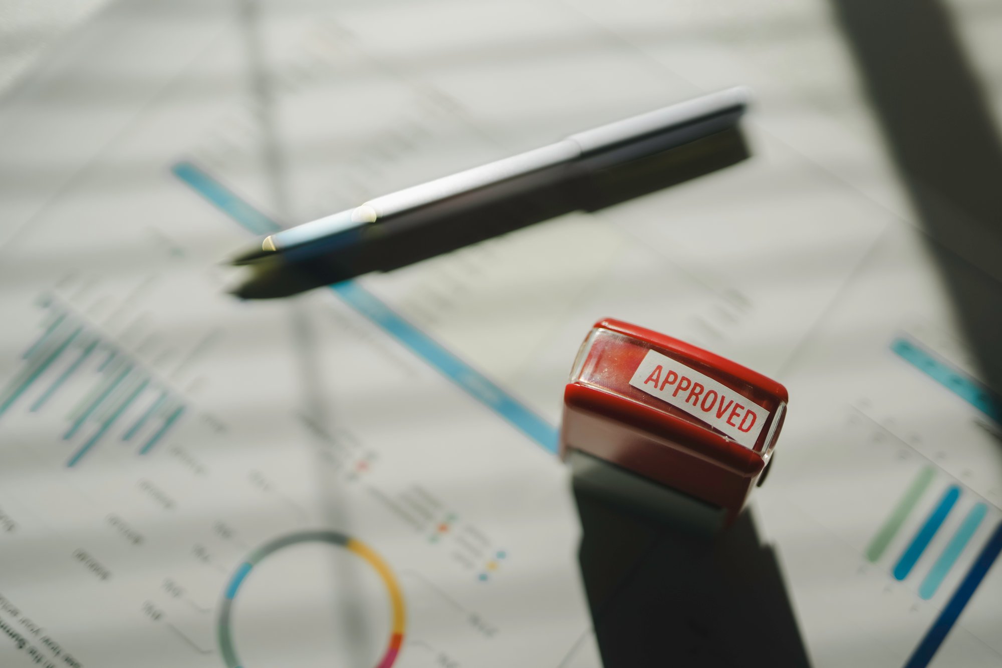 approved-stamp-on-financial-report-with-charts