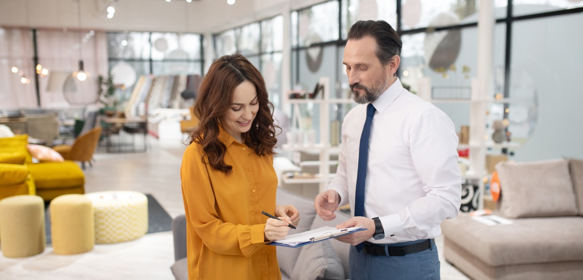 consultant-in-furniture-shop-talking-to-female-customer