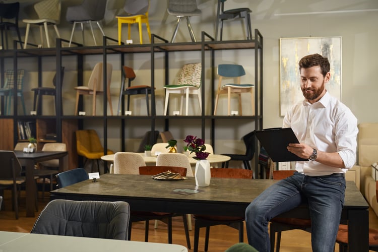 good-looking-busy-salesman-leaning-on-table-while-2025-03-27-01-43-31-utc-1
