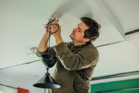 man-himself-repaired-lamp-on-the-ceiling-in-the-ki-2024-09-25-06-05-20-utc-1
