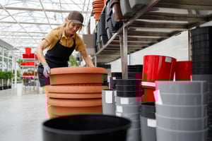 pretty-woman-moving-big-heavy-pot-in-garden-center-2024-10-20-10-15-51-utc-1