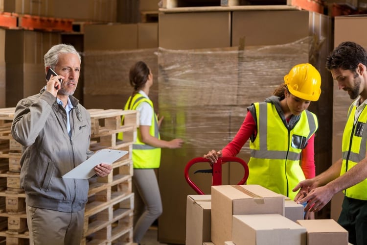 warehouse-manager-and-workers-preparing-a-shipment