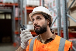 warehouse-worker-transmitting-message-to-colleague