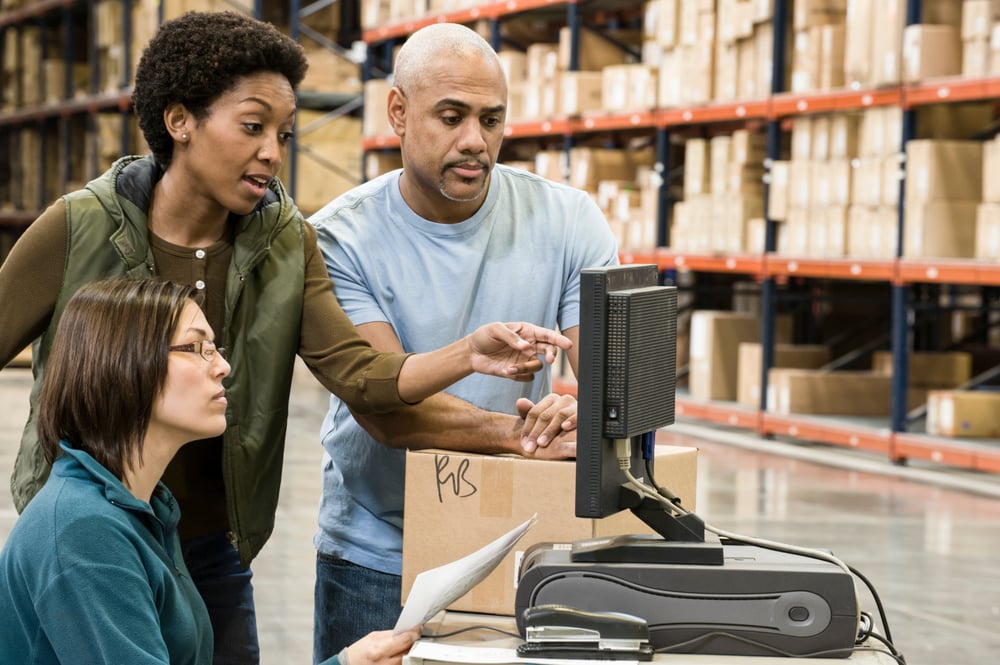 warehouse-workers-checking-inventory-on-a-computer