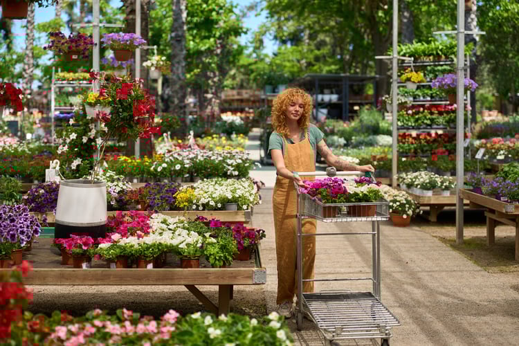 woman-gardener-pushing-cart-with-flowers-in-a-gard-2025-07-27-08-52-29-utc-1