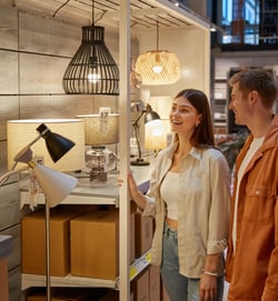 young-family-couple-choosing-chandelier-in-buildin-2024-11-27-19-31-06-utc-1